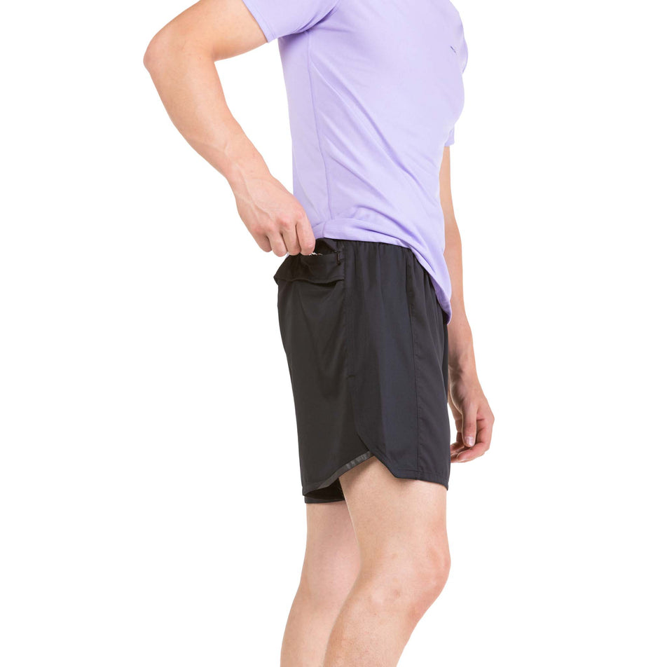 Side view of a model wearing a pair of Ronhill Men's Tech Revive 5