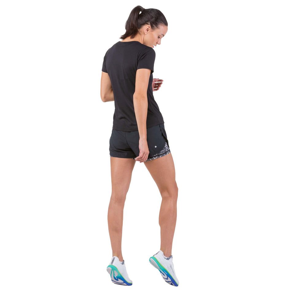 Back view of a model wearing a pair of Ronhill Women's Life Twin Shorts in the Black/Mono Magic Eye colourway (7749221187746)