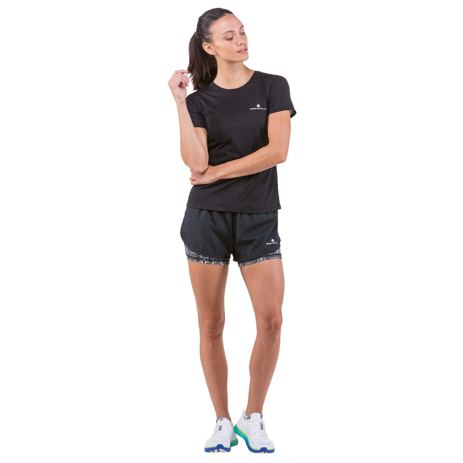 Front view of a model wearing a pair of Ronhill Women's Life Twin Shorts in the Black/Mono Magic Eye colourway (7749221187746)