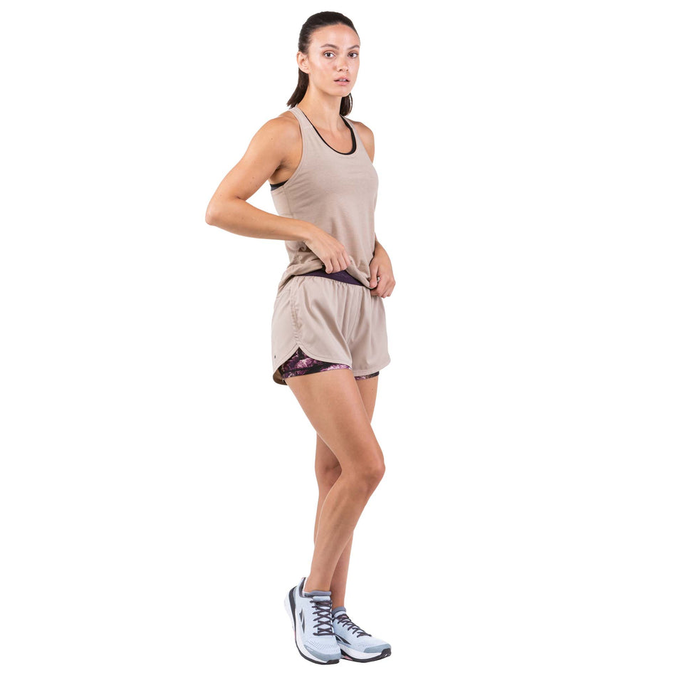 Angled front view of a model wearing a pair of Ronhill Women's Life Twin Shorts in the Latte/Nightshade Mountain colourway (7746223702178)