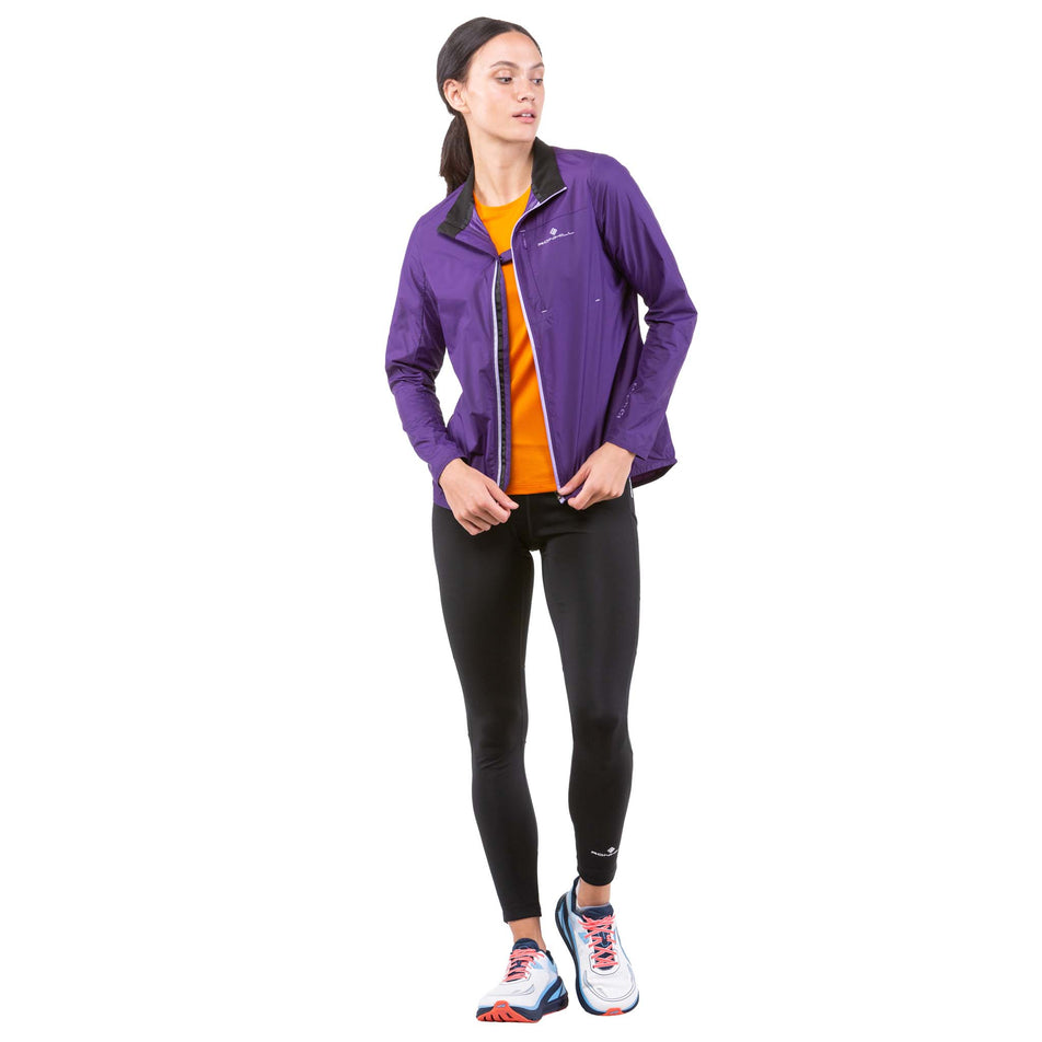 Front view of a model wearing a Ronhill Women's Tech LTW Jacket - unzipped (7844276043938)