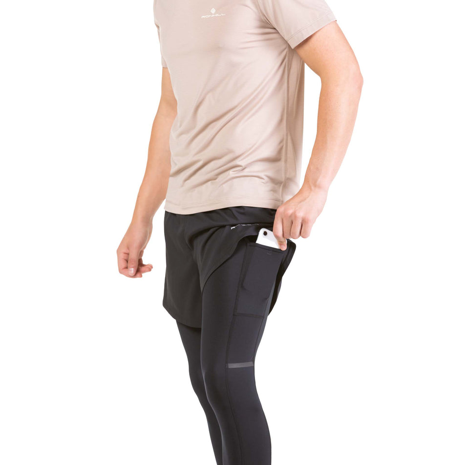 A model taking a phone out of the side leg pocket on a pair of Ronhill Men's Life Twin Tights  (7573989163170)