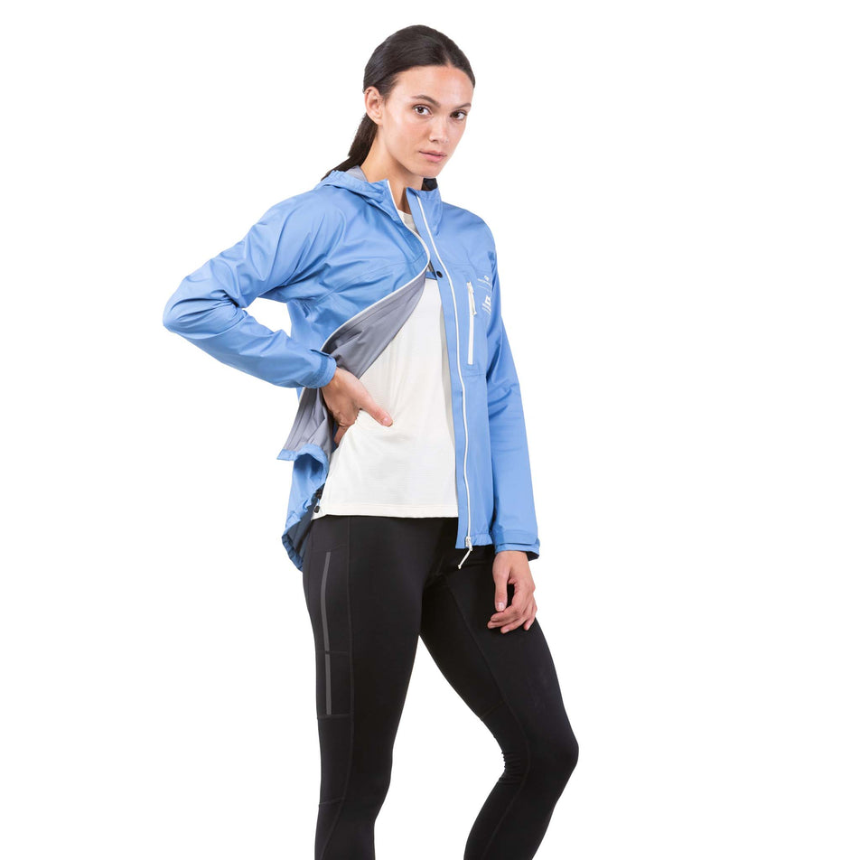 Side front view of a model wearing a Ronhill Women's Tech Mercurial Jacket - jacket unzipped (7742604837026)