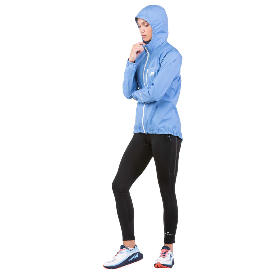 Front view of a model wearing a Ronhill Women's Tech Mercurial Jacket with the hood up (7742604837026)