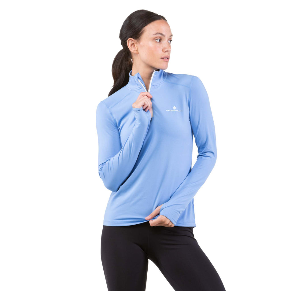 Front view of a model wearing a Ronhill Women's Life Practice 1/2 Zip Tee, with zip half-zipped up (7742592188578)