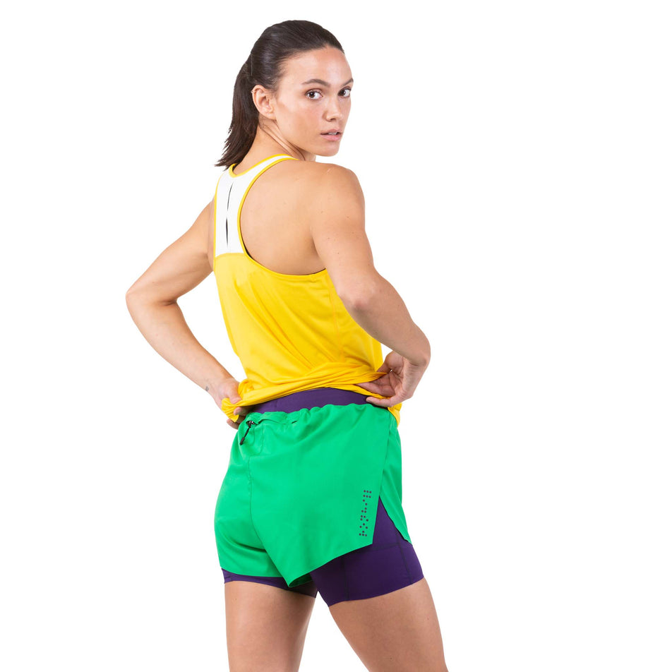 Back view of a model wearing a pair of Ronhill Women's Tech Distance Twin Shorts (7744909050018)