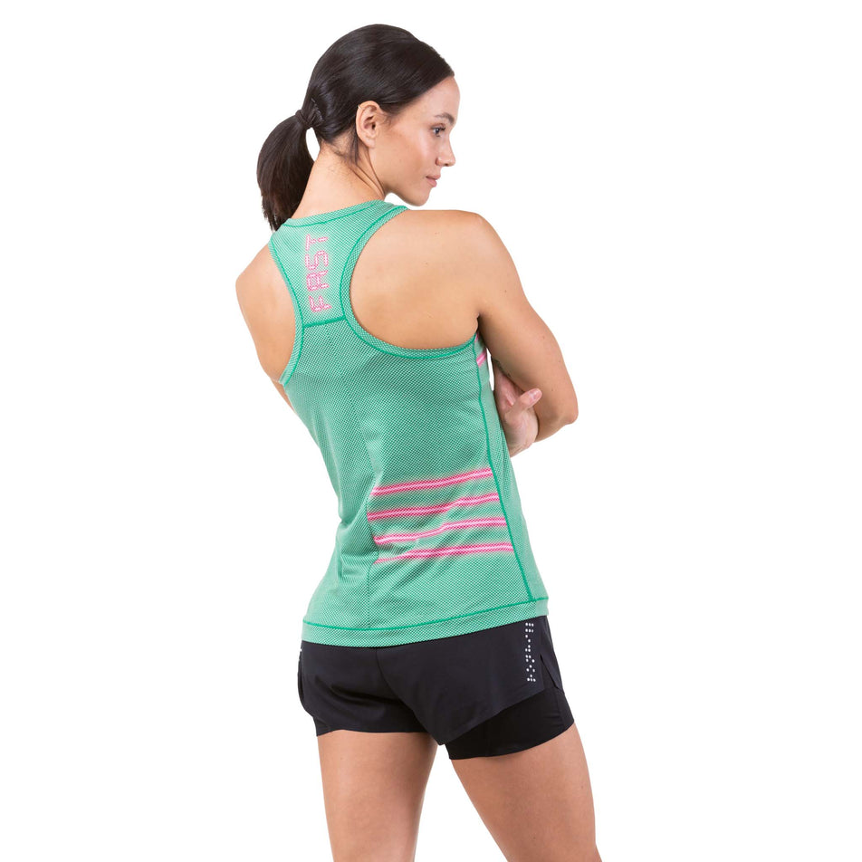 Back view of a model wearing a Ronhill Women's Tech Golden Hour Vest (7744875724962)