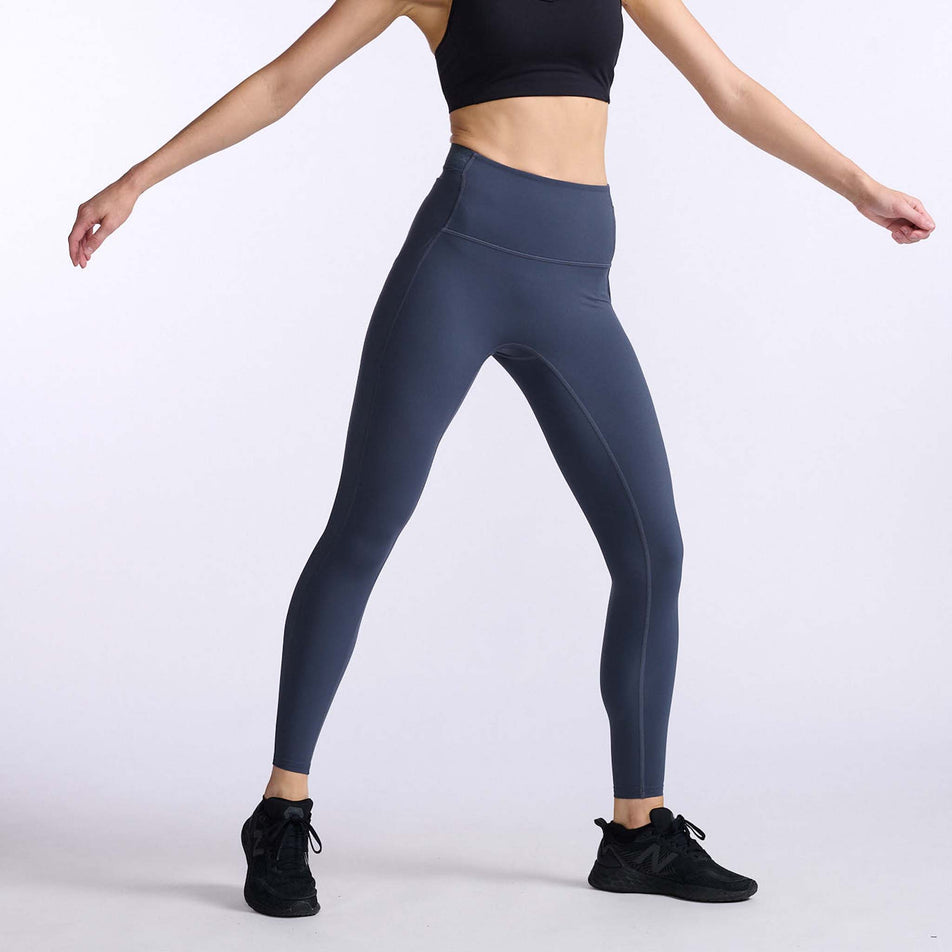 Front view of a model wearing a pair of 2XU Women's Form Stash Hi-Rise Compression Tights (7778519842978)