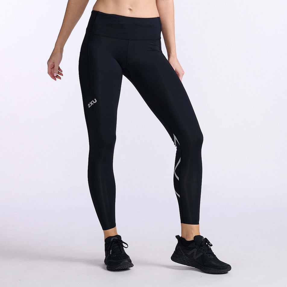 Front view of a model wearing a pair of 2XU Women's Aero Mid-Rise Compression Tights (7778495660194)